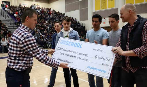 Powerade representative Seth Holm presents a $2,000 check to LHS's Scott Bueller. Joining Bueller L to R are Todd Johnson, Ethan Powers, Nicholas Leon, and Branden Kaiser. The four helped to make the video.